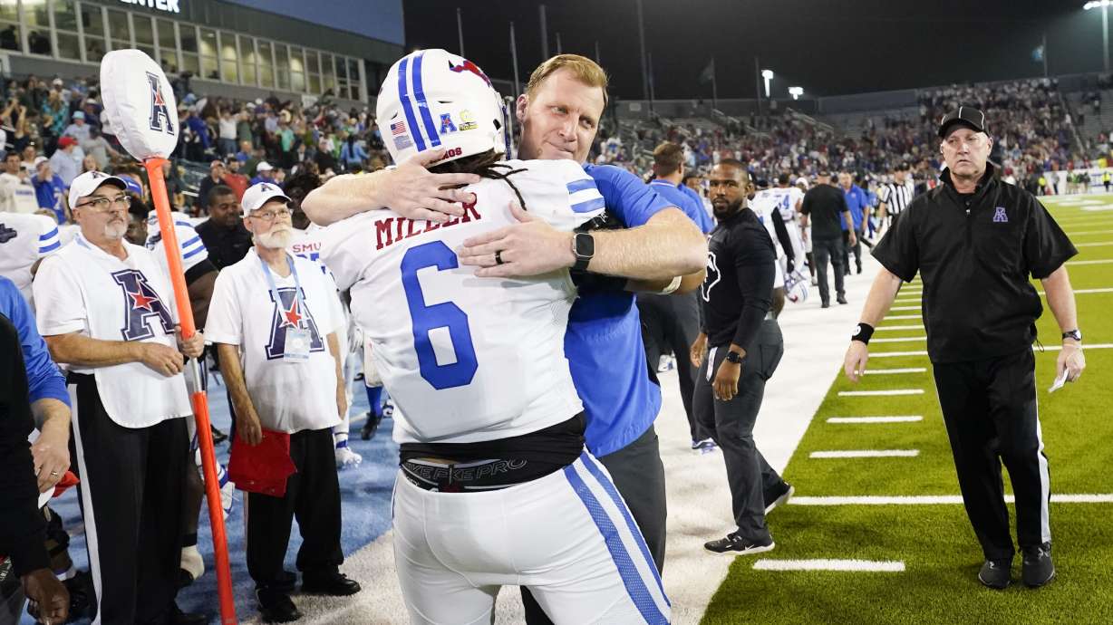 SMU head coach Rhett Lashlee hugs defensive tackle Jordan Miller (6) during the second half of the American Athletic Conference championship NCAA college football game against Tulane, Saturday, Dec. 2, 2023 in New Orleans. SMU won 26-14.