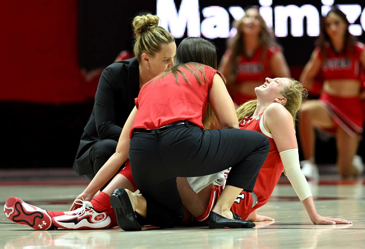 Utah Utes guard Gianna Kneepkens (5) grimaces in pain after being injured in the fourth quarter as Utah and BYU women play at the Huntsman Center in Salt Lake City on Saturday, Dec. 2, 2023. Utah won 87-68.