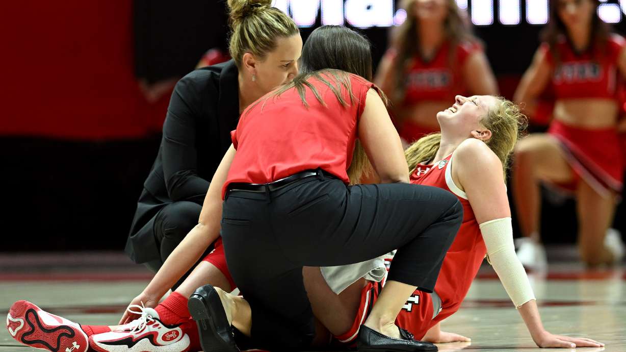 Utah Utes guard Gianna Kneepkens (5) grimaces in pain after being injured in the fourth quarter as Utah and BYU women play at the Huntsman Center in Salt Lake City on Saturday, Dec. 2, 2023. Utah won 87-68.