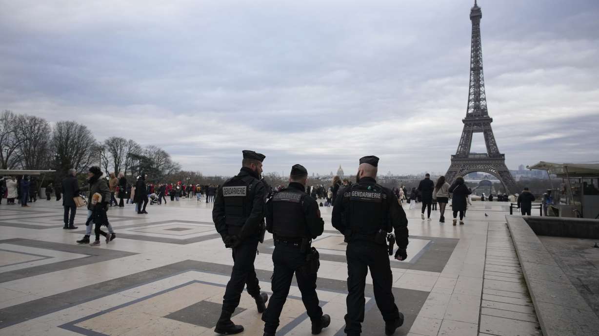French gendarmes patrol the Trocadero plaza near the Eiffel Tower after a man targeted passersby late Saturday, killing a German tourist with a knife and injuring two others in Paris, Sunday.