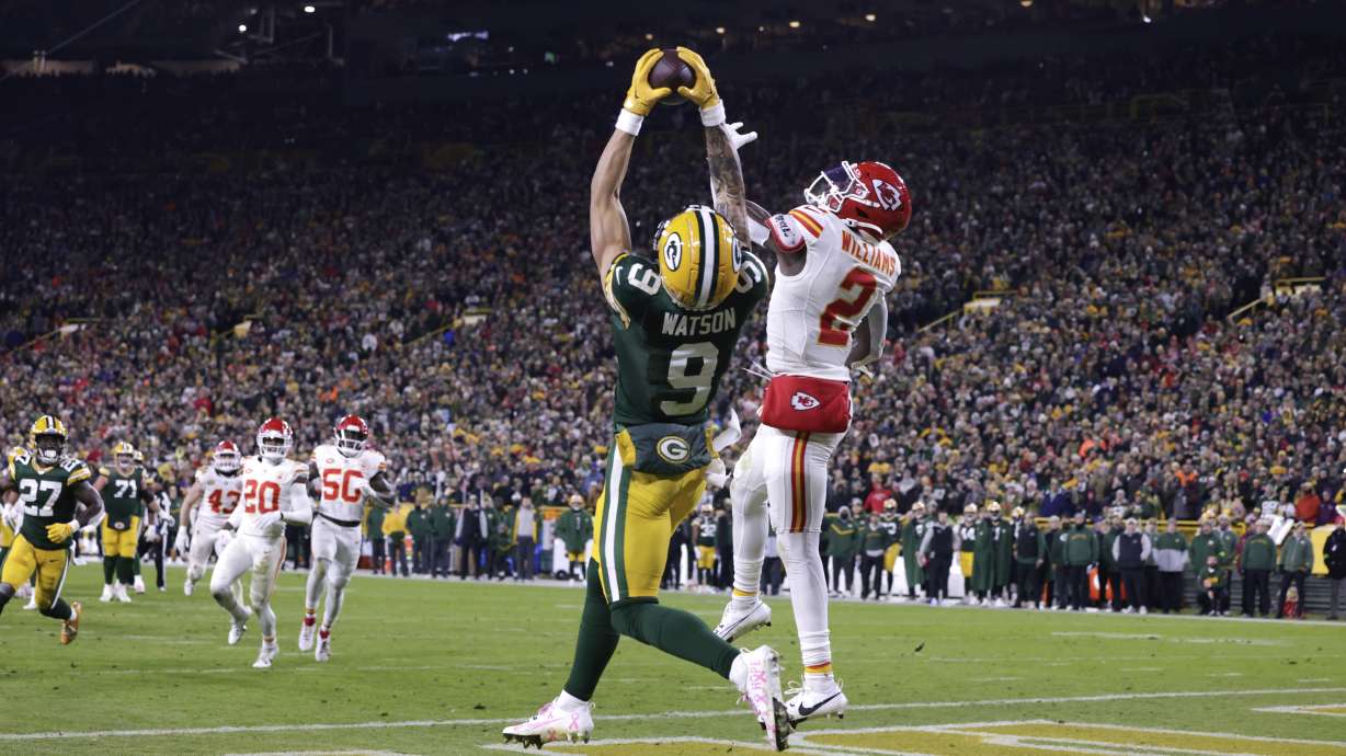 Green Bay Packers wide receiver Christian Watson (9) catches a 12-yard touchdown pass as Kansas City Chiefs cornerback Joshua Williams (2) defends during the second half of an NFL football game Sunday, Dec. 3, 2023 in Green Bay, Wis.