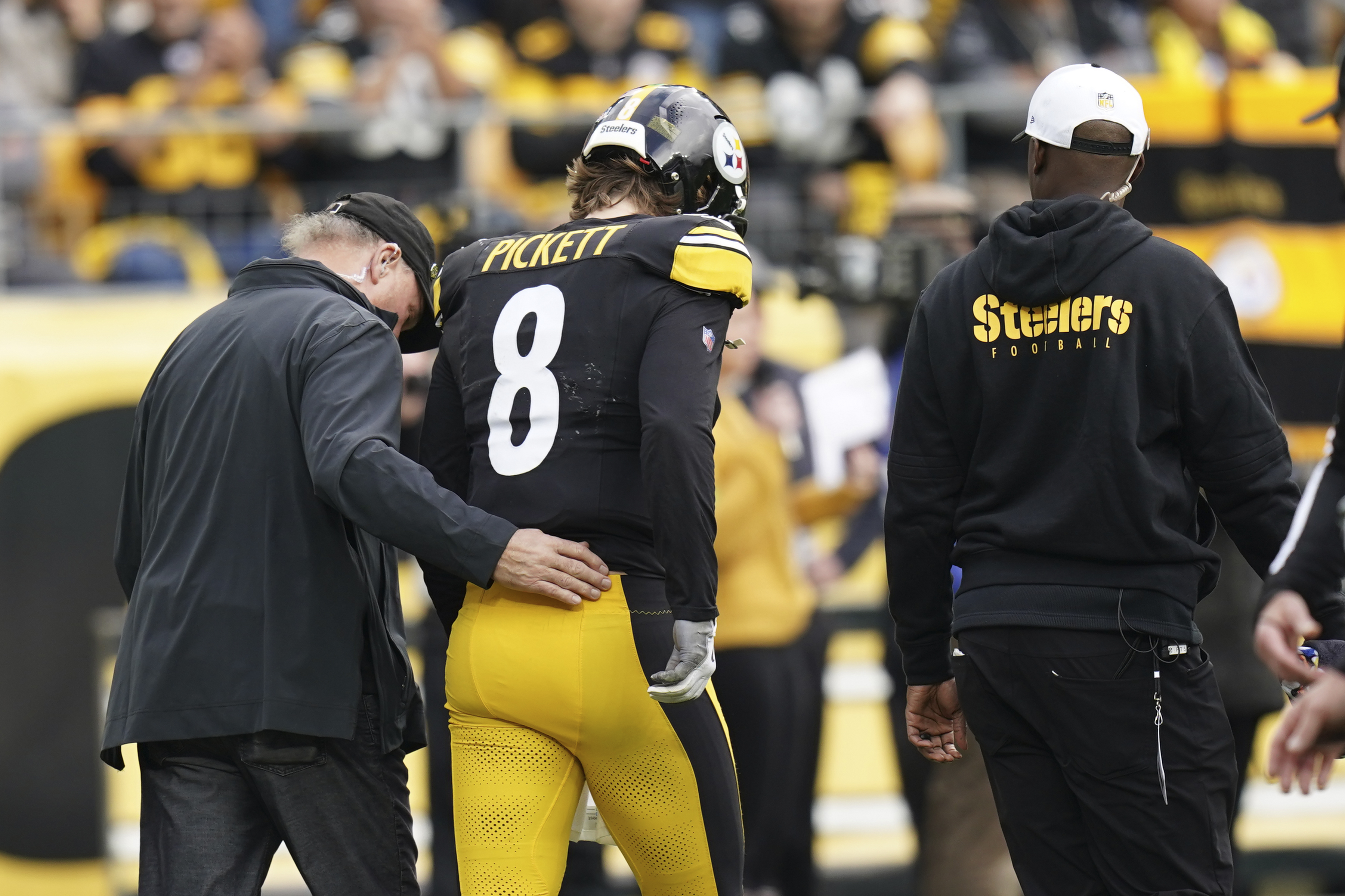 Pittsburgh Steelers quarterback Kenny Pickett (8) is helped off the field due to injury during the first half of an NFL football game against the Arizona Cardinals, Sunday, Dec. 3, 2023, in Pittsburgh.