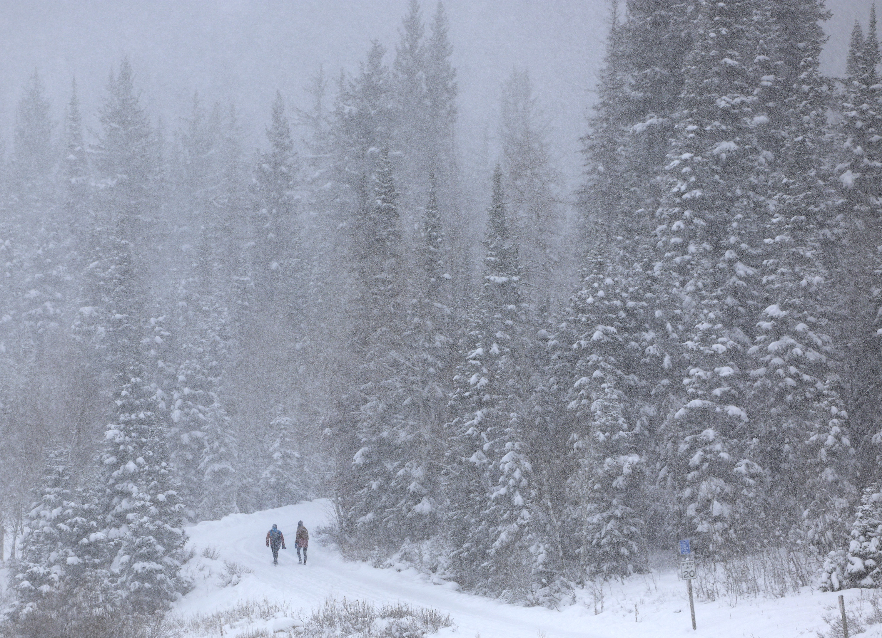 People hike to Donut Falls in Big Cottonwood Canyon on Friday. An atmospheric river that hit parts of Utah this weekend produced more than originally forecast, which provided significant snow totals in the mountains.