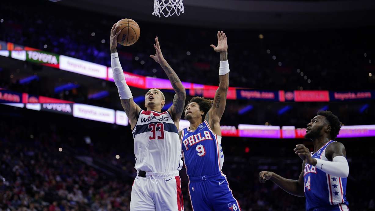 Washington Wizards' Kyle Kuzma (33) goes up for a shot against Philadelphia 76ers' Kelly Oubre Jr. (9) during the first half of an NBA basketball game, Monday, Nov. 6, 2023, in Philadelphia.
