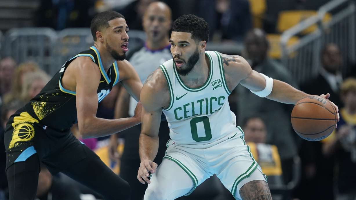 Boston Celtics' Jayson Tatum, right, is defended by Indiana Pacers' Tyrese Haliburton, left, during the first half half of an NBA basketball In-Season Tournament game, Monday, Dec. 4, 2023, in Indianapolis.