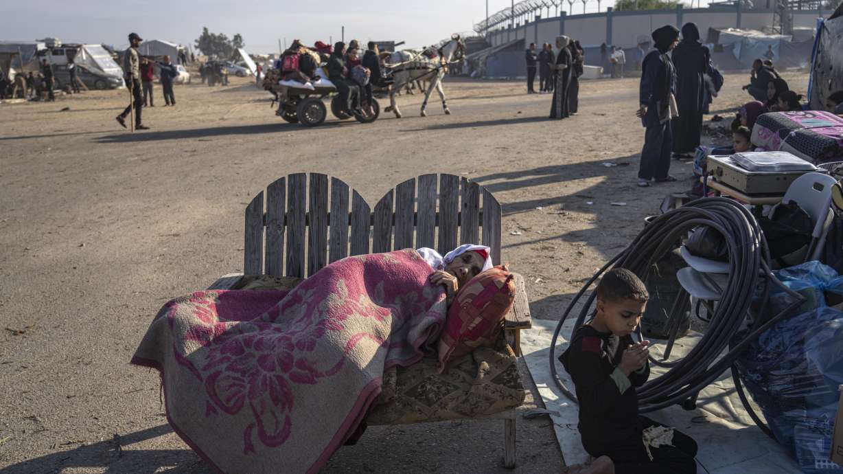 Palestinians displaced by the Israeli bombardment of the Gaza Strip gather at a tent camp, in Rafah, southern Gaza Strip, Monday. Hundreds of thousands of Palestinians have fled their homes as Israel moves ahead with a ground offensive against the ruling Hamas militant group.