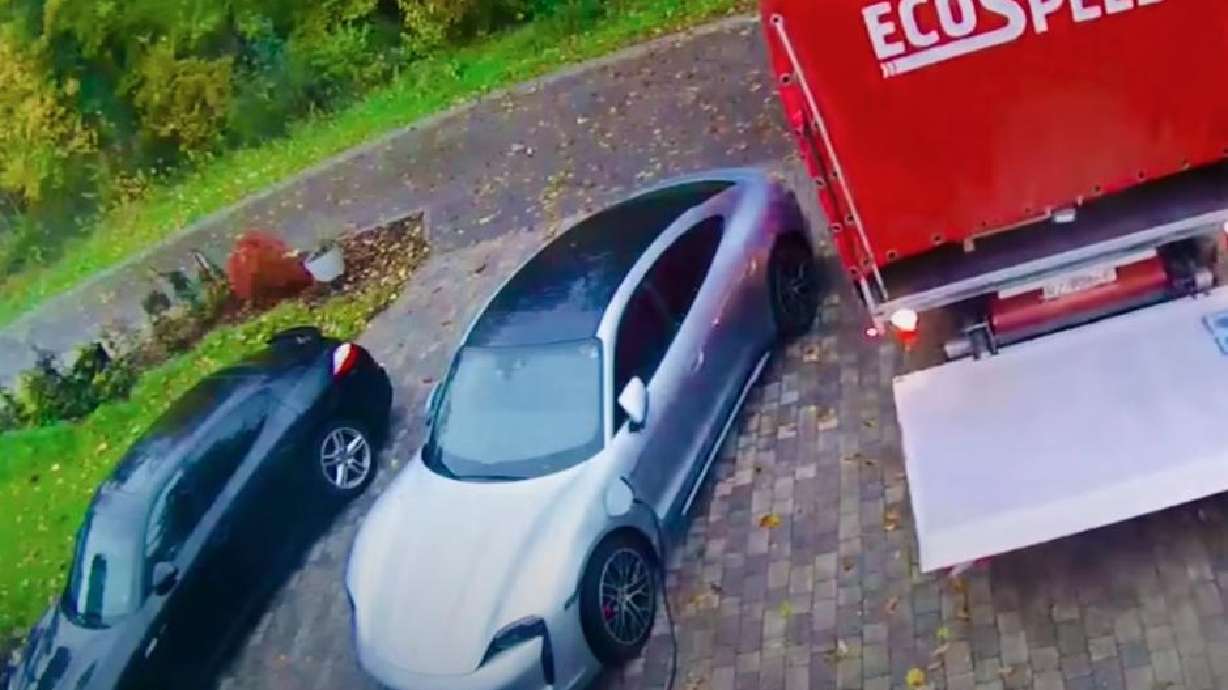Delivery driver comes awfully close to an expensive Porsche in Rossignol, Belgium, Oct. 31.