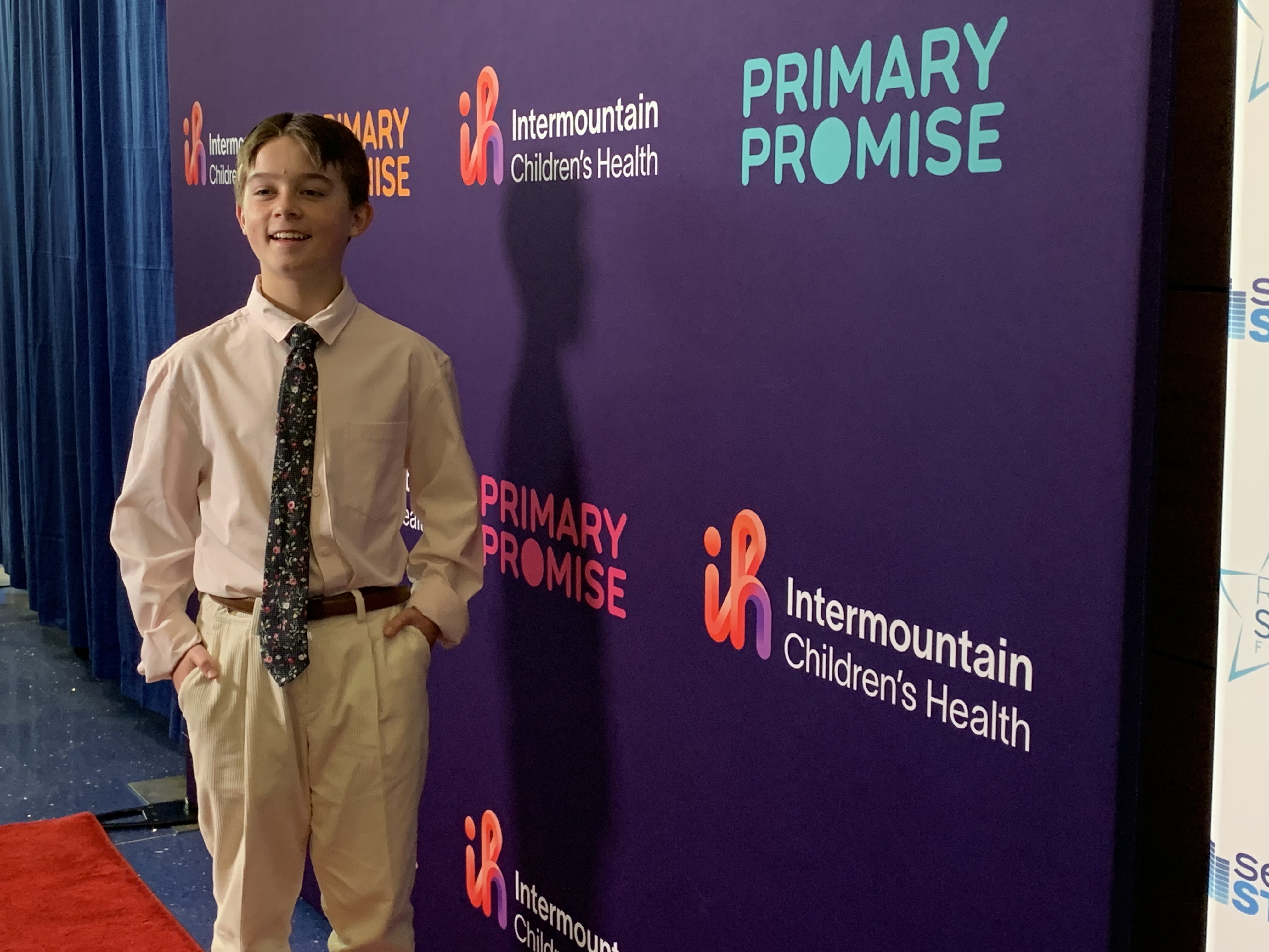 Payson Inkley, a patient at Primary Children's Hospital in Salt Lake City, poses on the red carpet before the opening of the hospital's new Seacrest Studio on Tuesday. Celebrity talk show host Ryan Seacrest and his sister, Meredith Seacrest Leach, executive director of the Seacrest Foundation that created the broadcast studio, were on hand for its grand opening Tuesday.