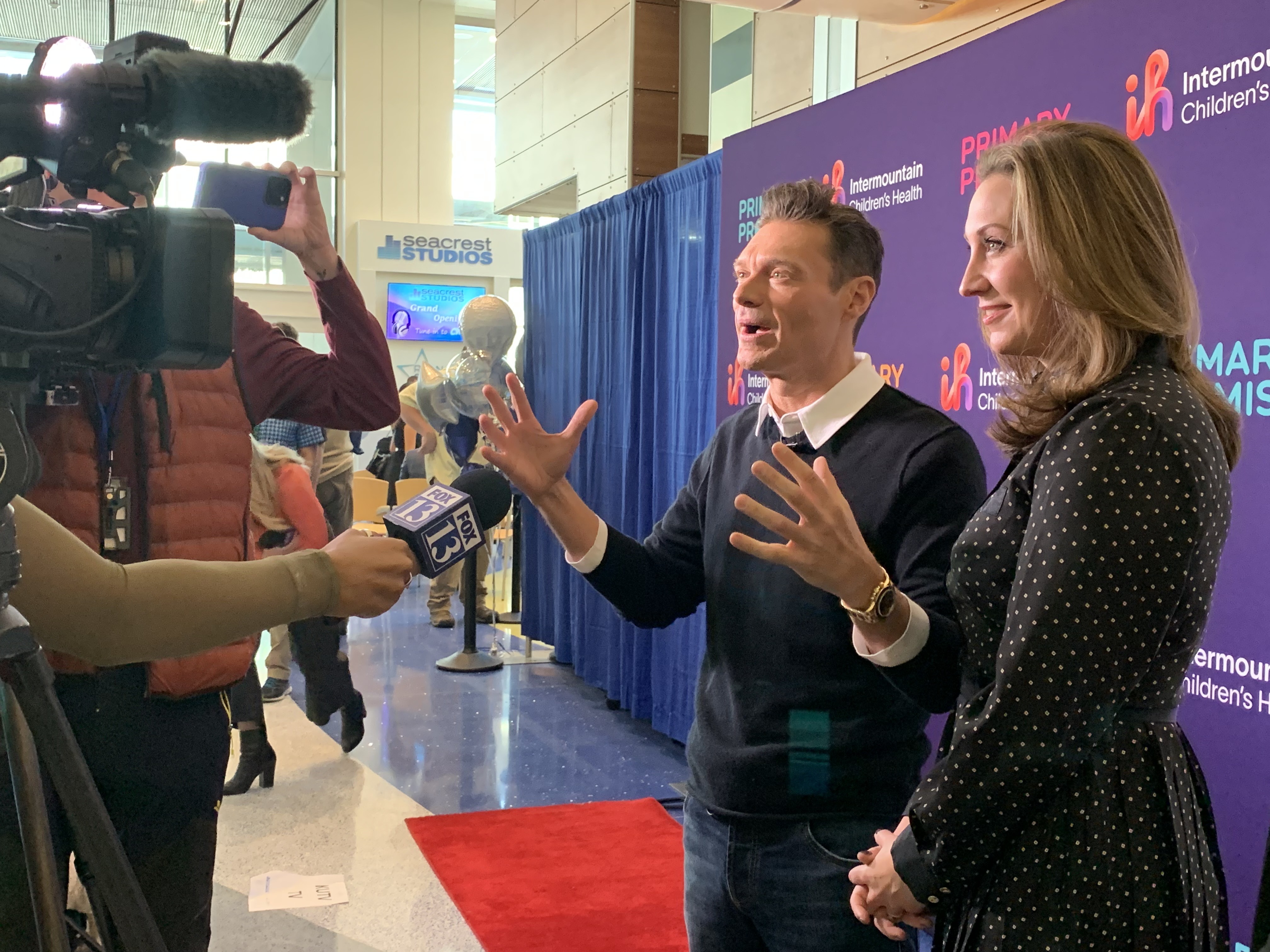 Ryan Seacrest and his sister, Meredith Seacrest Leach, executive director of the Seacrest Foundation, speak with reporters before the opening of the Seacrest Studio at Primary Children's Hospital in Salt Lake City on Tuesday.