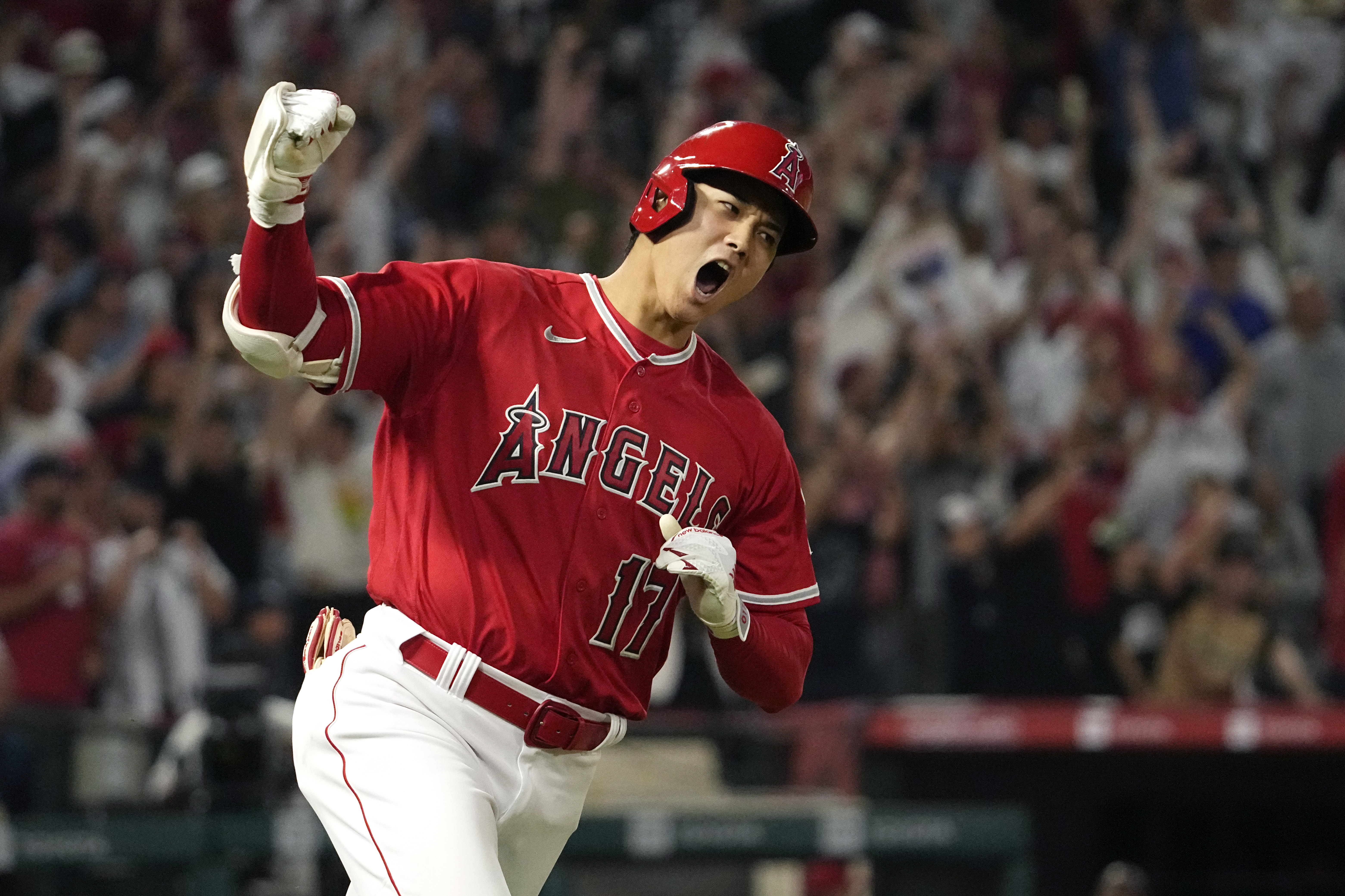 FILE - Los Angeles Angels' Shohei Ohtani celebrates as he rounds first after hitting a two-run home run during the seventh inning of a baseball game against the New York Yankees Monday, July 17, 2023, in Anaheim, Calif. Shohei Ohtani is a favorite to win his second AL Most Valuable Player award, Thursday, Nov. 16, 2023.