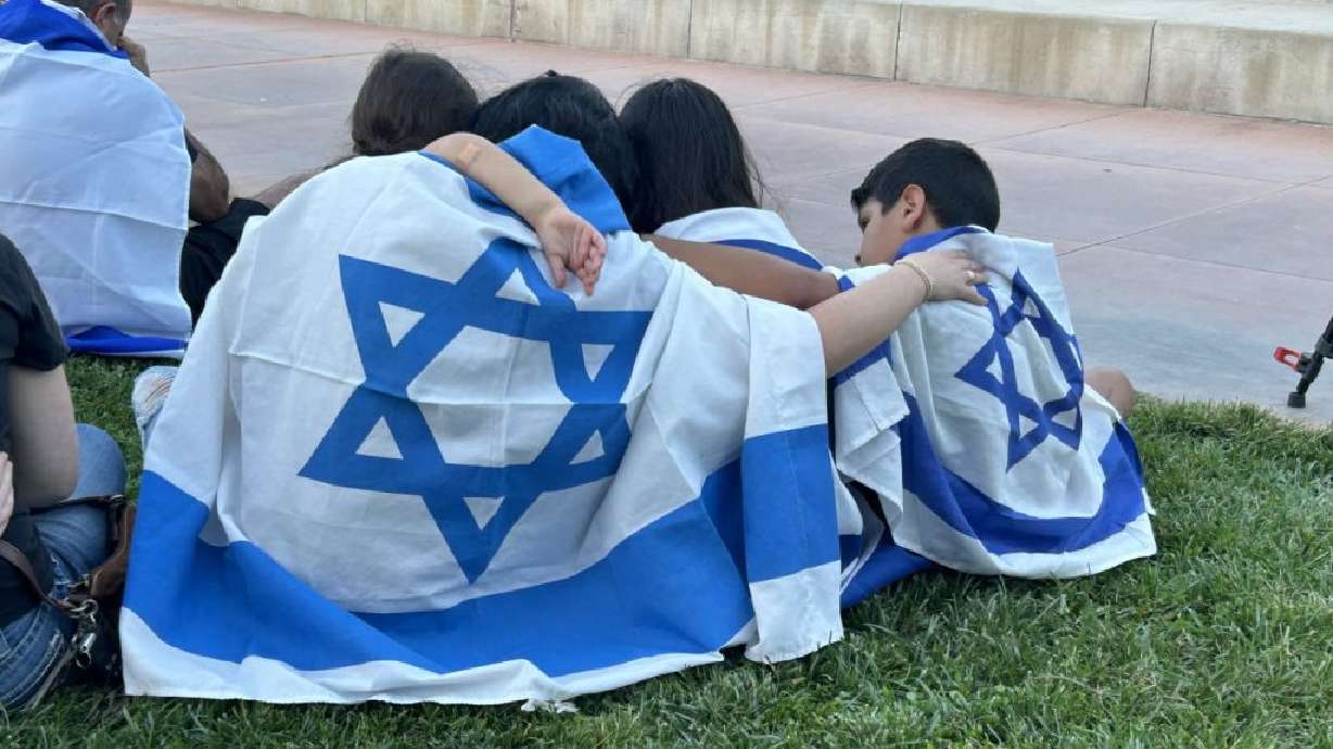 A family embraces during a pro-Israel rally in Town Square in St. George on Oct 11. The upcoming Hanukkah season is an important holiday for southern Utah's Jewish community during a time of war between Israeli forces and Hamas militants half a world away.