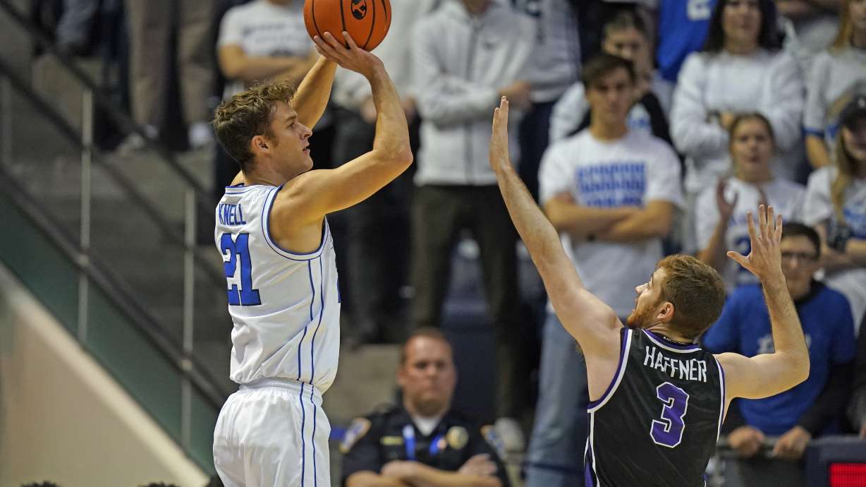 BYU guard Trevin Knell (21) shoots as Evansville guard Cameron Haffner (3) defends during the first half of an NCAA college basketball game Tuesday, Dec. 5, 2023, in Provo, Utah.