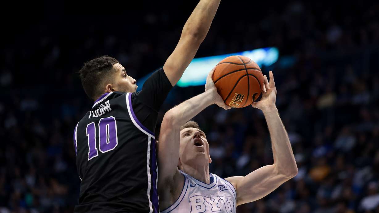 BYU guard Spencer Johnson (20) goes to the hoop against Evansville Aces forward Yacine Toumi (10) at the Marriott Center in Provo on Tuesday, Dec. 5, 2023.