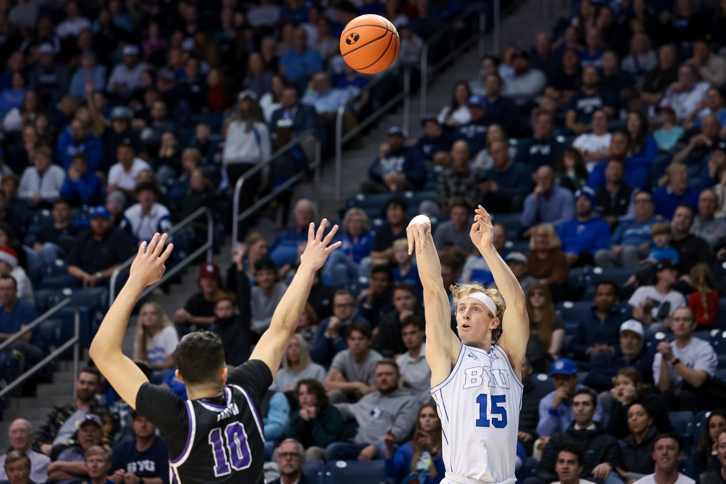 BYU guard Richie Saunders (15) shoots over Evansville Aces forward Yacine Toumi (10) during the game at the Marriott Center in Provo on Tuesday, Dec. 5, 2023.