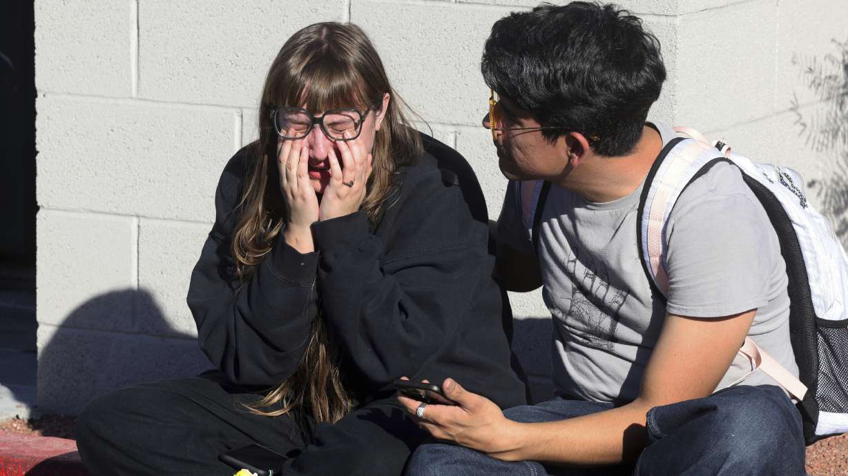 Amanda Perez, left, is comforted by fellow student Alejandro Barron following a shooting on the University of Nevada, Las Vegas campus, Wednesday in Las Vegas.