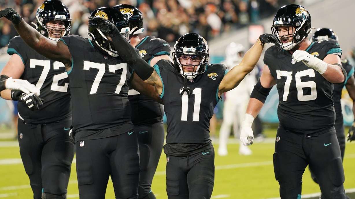 Jacksonville Jaguars wide receiver Parker Washington (11) celebrates after scoring a touchdown during the second half of an NFL football game, Monday, Dec. 4, 2023, in Jacksonville, Fla.