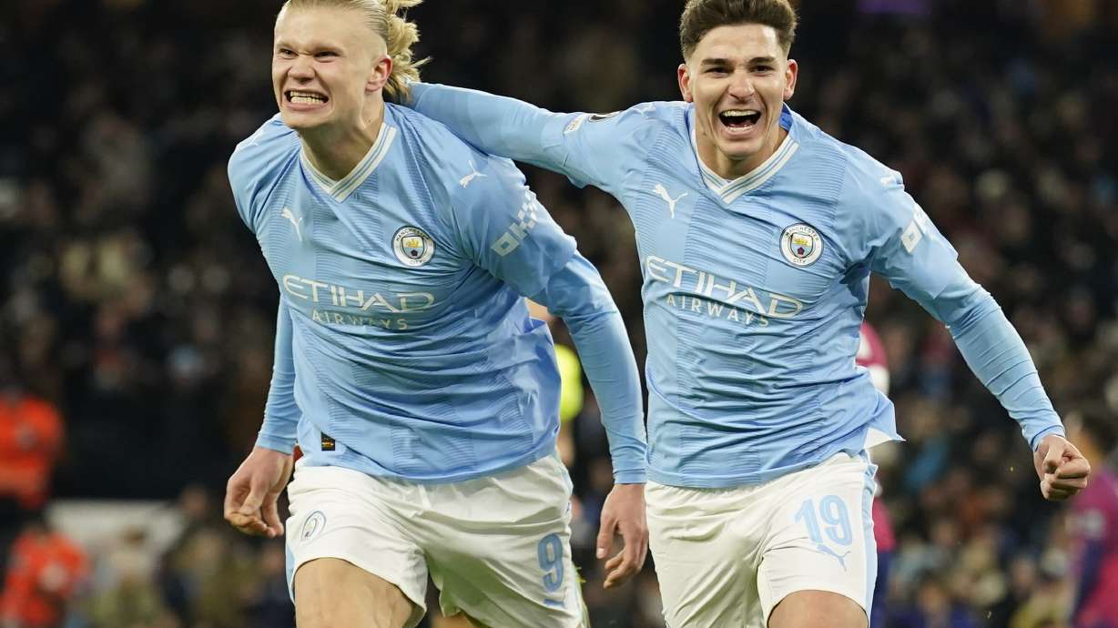 Manchester City's Julian Alvarez, right, celebrates with Manchester City's Erling Haaland after scoring his side's third goal during the group G Champions League soccer match between Manchester City and RB Leipzig at the Etihad stadium in Manchester, England, Tuesday, Nov. 28, 2023.