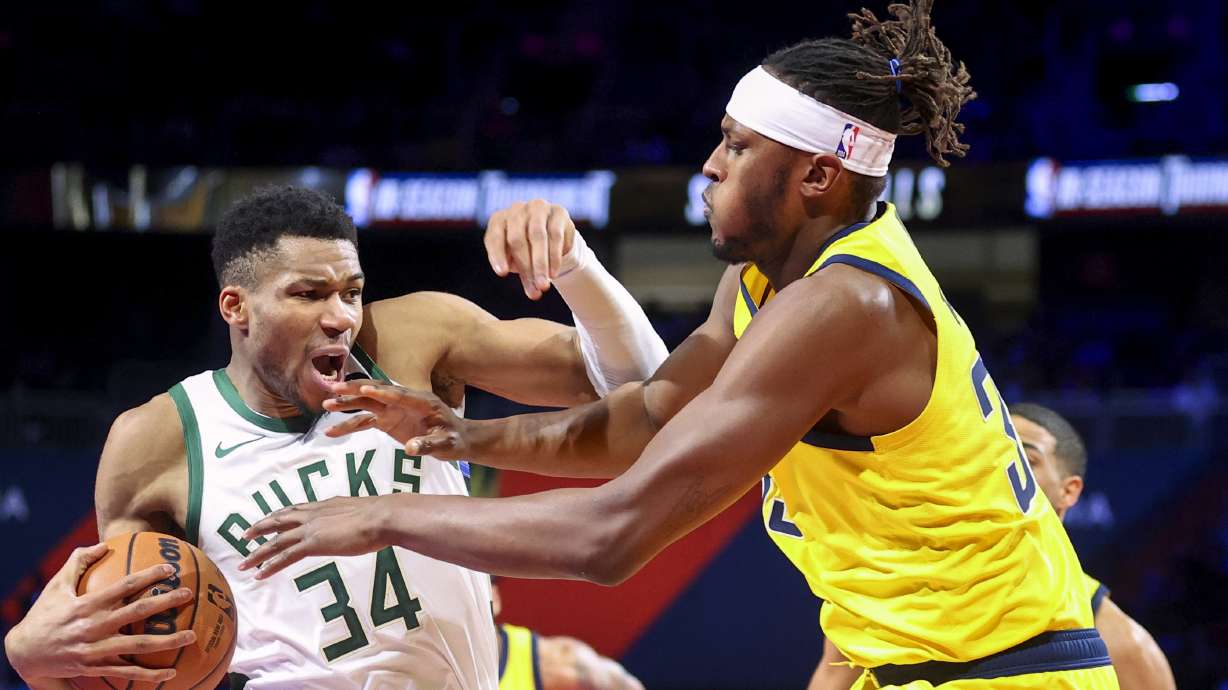 Milwaukee Bucks forward Giannis Antetokounmpo (34) reacts while Indiana Pacers center Myles Turner, front right, defends during the first half of a semifinal game in the NBA basketball In-Season Tournament, Thursday, Dec. 7, 2023, in Las Vegas.
