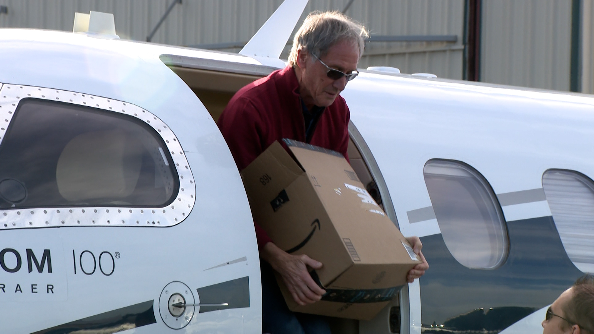 Pilot Hans Feugi unloads gifts from a plane in St. George on Thursday. Pilots gather cash donations, school supplies and toys for schools as part of the Angel Flight program.