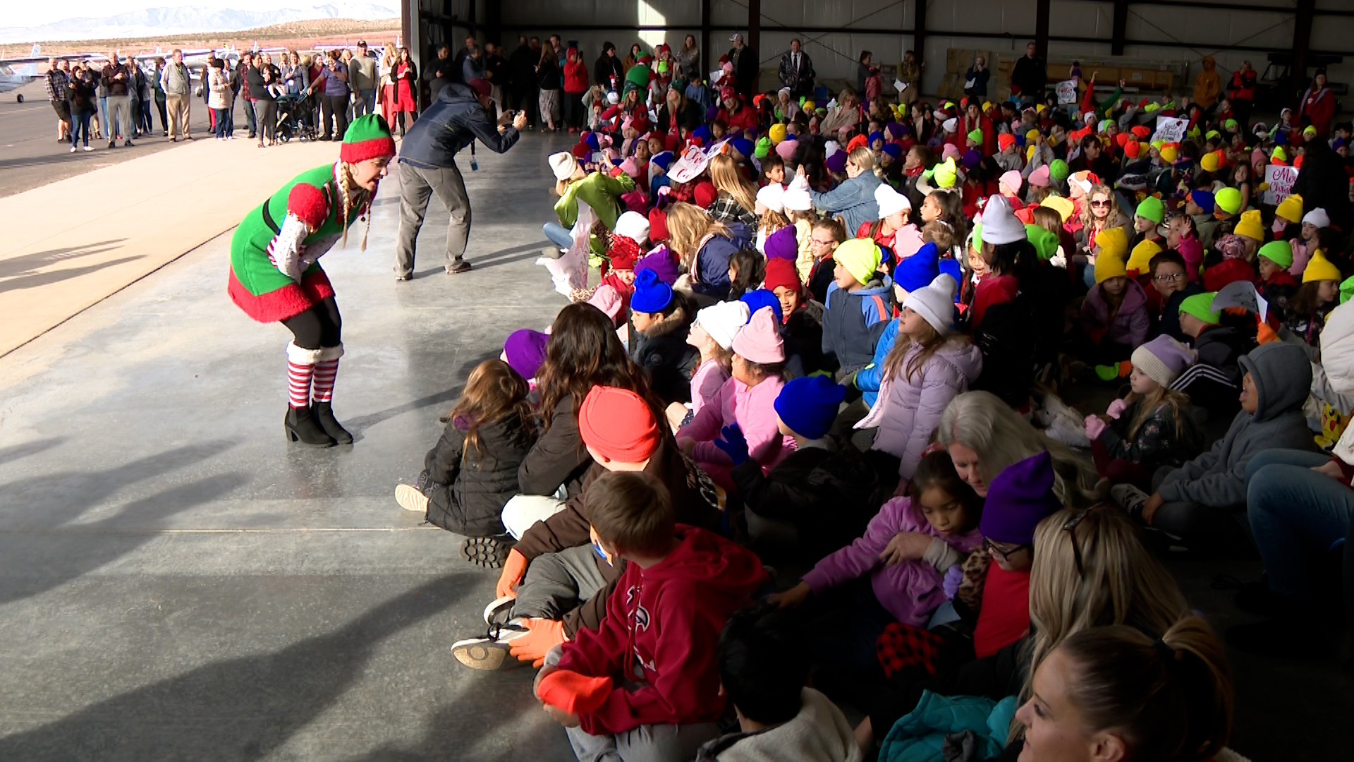 Children from Sunset Elementary are greeted by Santa’s elves in St. George Thursday. Pilots gather cash donations, school supplies and toys for schools as part of the Angel Flight program.