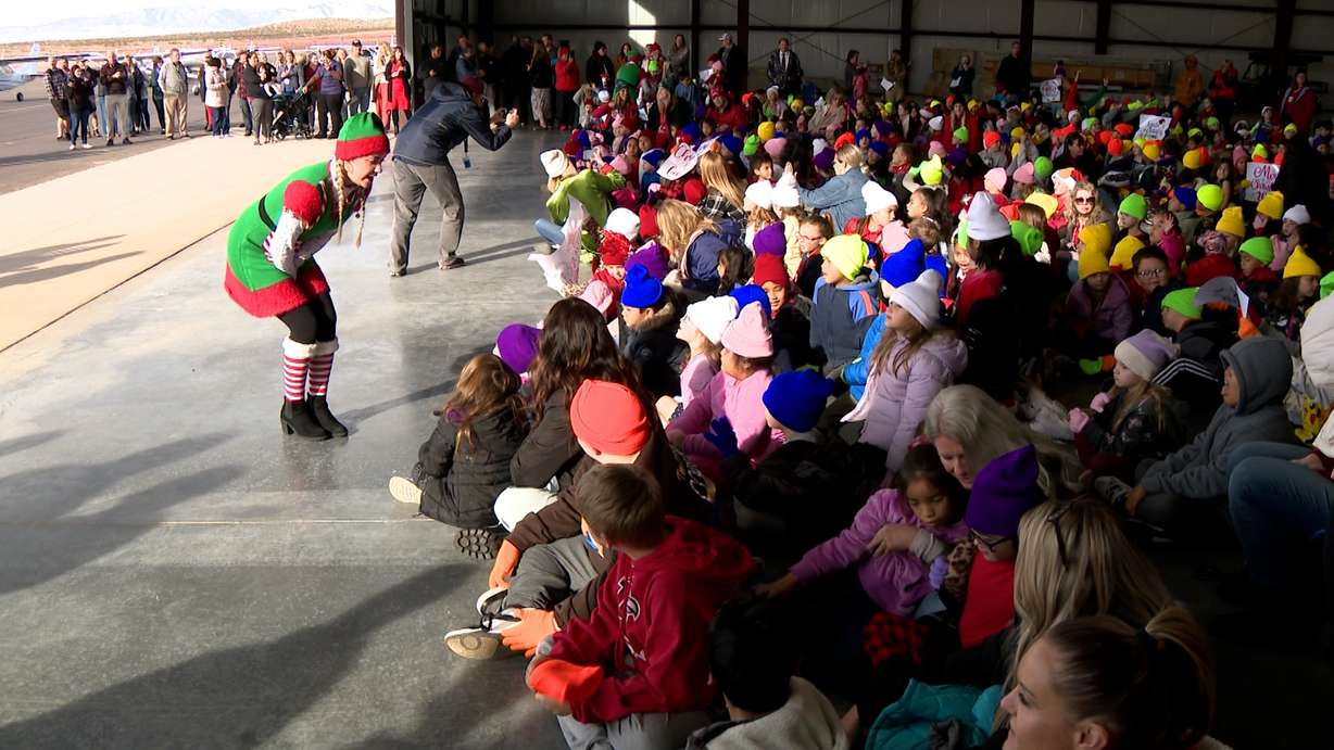 Children from Sunset Elementary are greeted by Santa’s elves in St. George Thursday. Pilots gather cash donations, school supplies and toys for schools as part of the Angel Flight program.