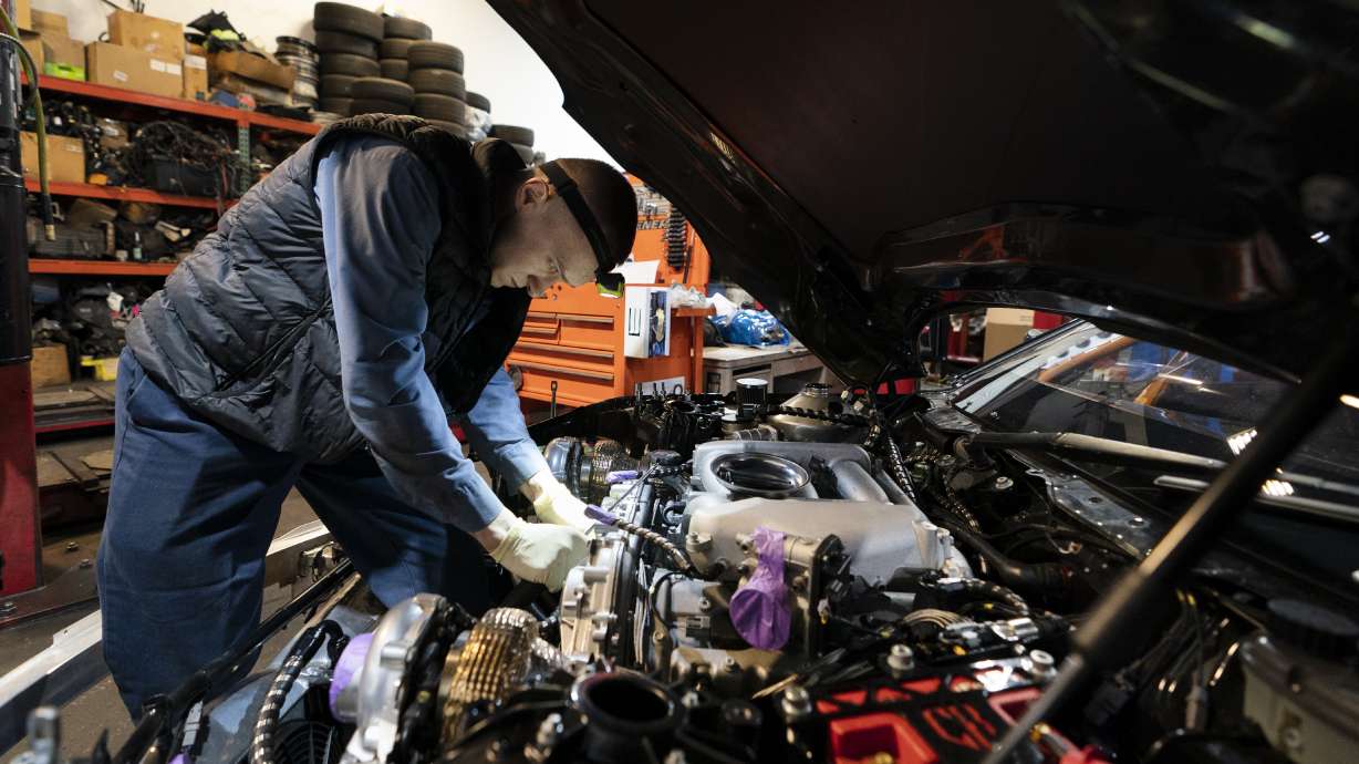 Mechanic David Stoliaruk works on the engine of a car at IC Auto in Philadelphia, May 2. U.S. employers added a healthy 199,000 jobs in November, the government reported Friday.