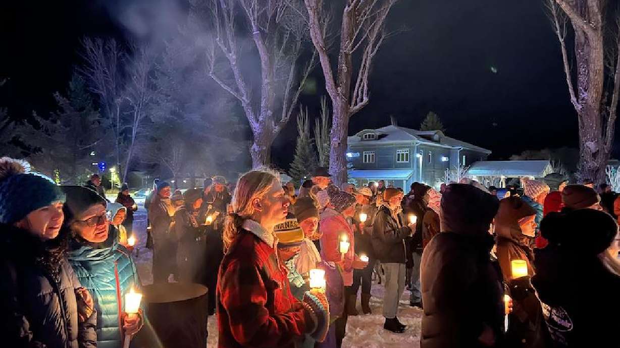 People hold candles during a vigil for Kali Randall and Zeke Best in Victor, Idaho on Thursday.