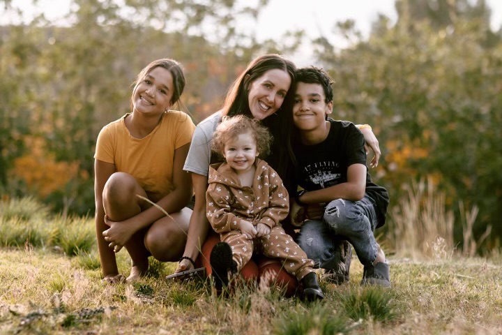Christine Sara, center, and Noah McArthur, right, pictured with their family.