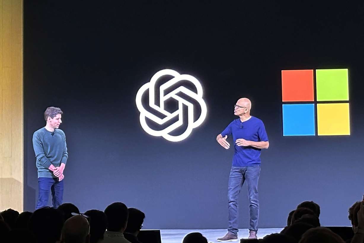 OpenAI CEO Sam Altman, left, appears onstage with Microsoft CEO Satya Nadella at OpenAI's first developer conference, on Nov. 6, in San Francisco.