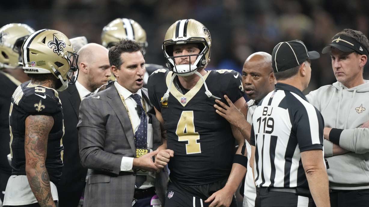 New Orleans Saints quarterback Derek Carr (4) is helped off the field during the second half of an NFL football game against the Detroit Lions, Sunday, Dec. 3, 2023, in New Orleans.