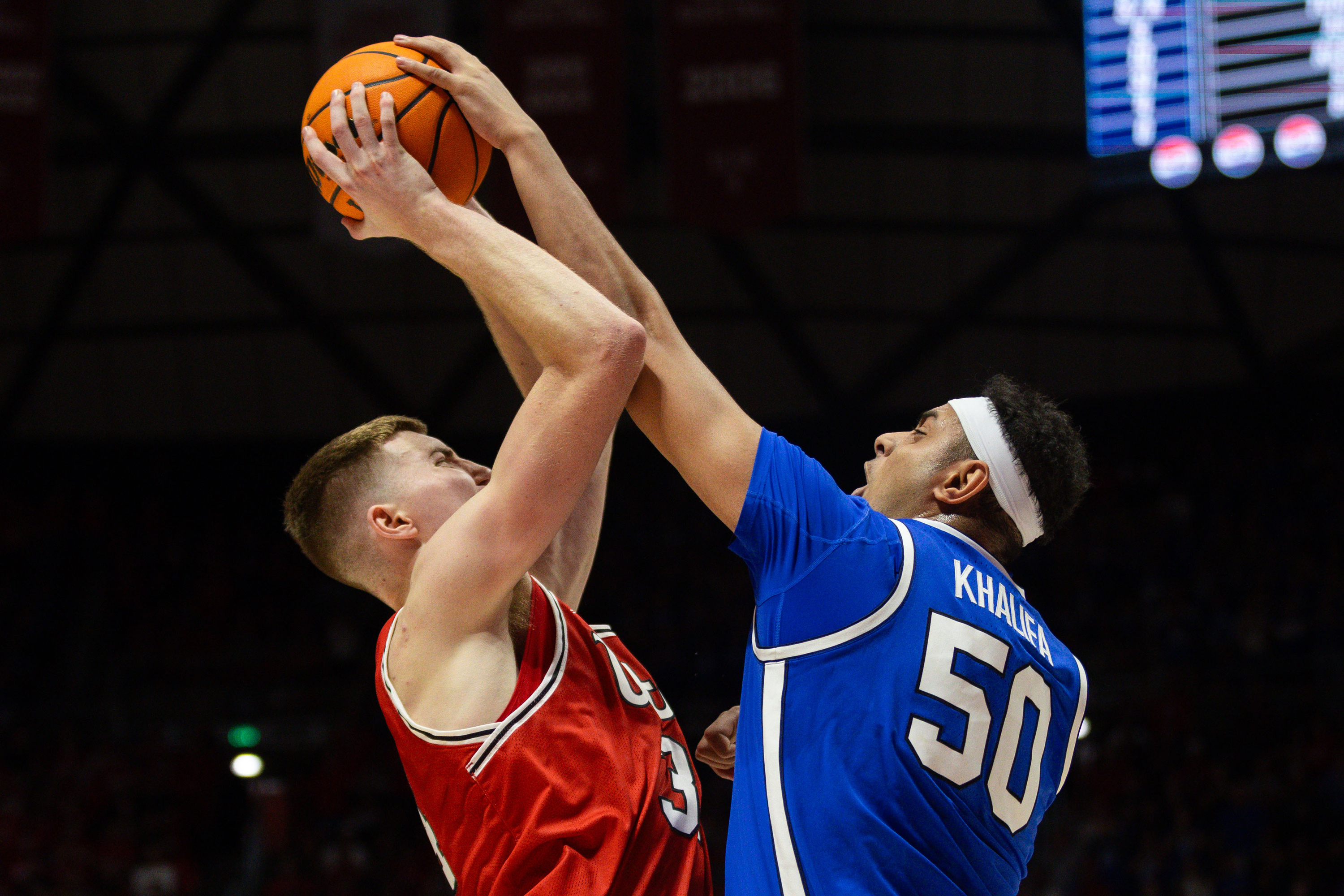 Utah center Lawson Lovering (34) is defended by Brigham Young center Aly Khalifa (50) on the shot during a men’s basketball game at the Jon M. Huntsman Center in Salt Lake City on Saturday, Dec. 9, 2023.