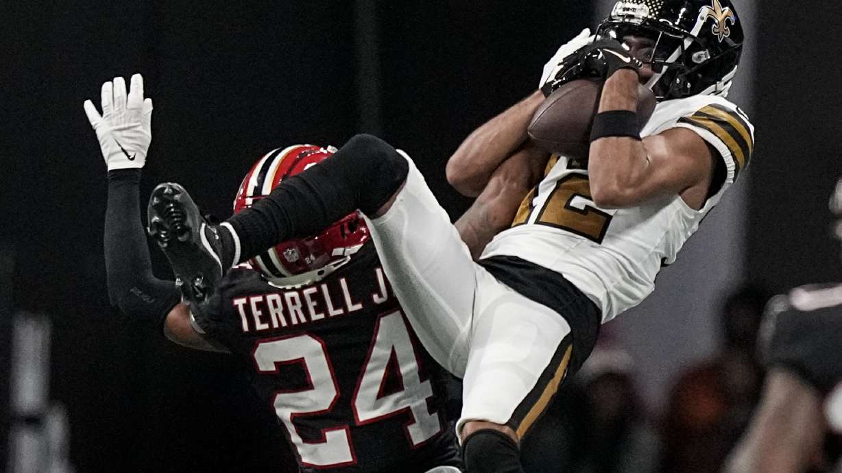 Atlanta Falcons cornerback A.J. Terrell (24) breaks up a pass against New Orleans Saints wide receiver Chris Olave (12) during the second half of an NFL football game, Sunday, Nov. 26, 2023, in Atlanta.