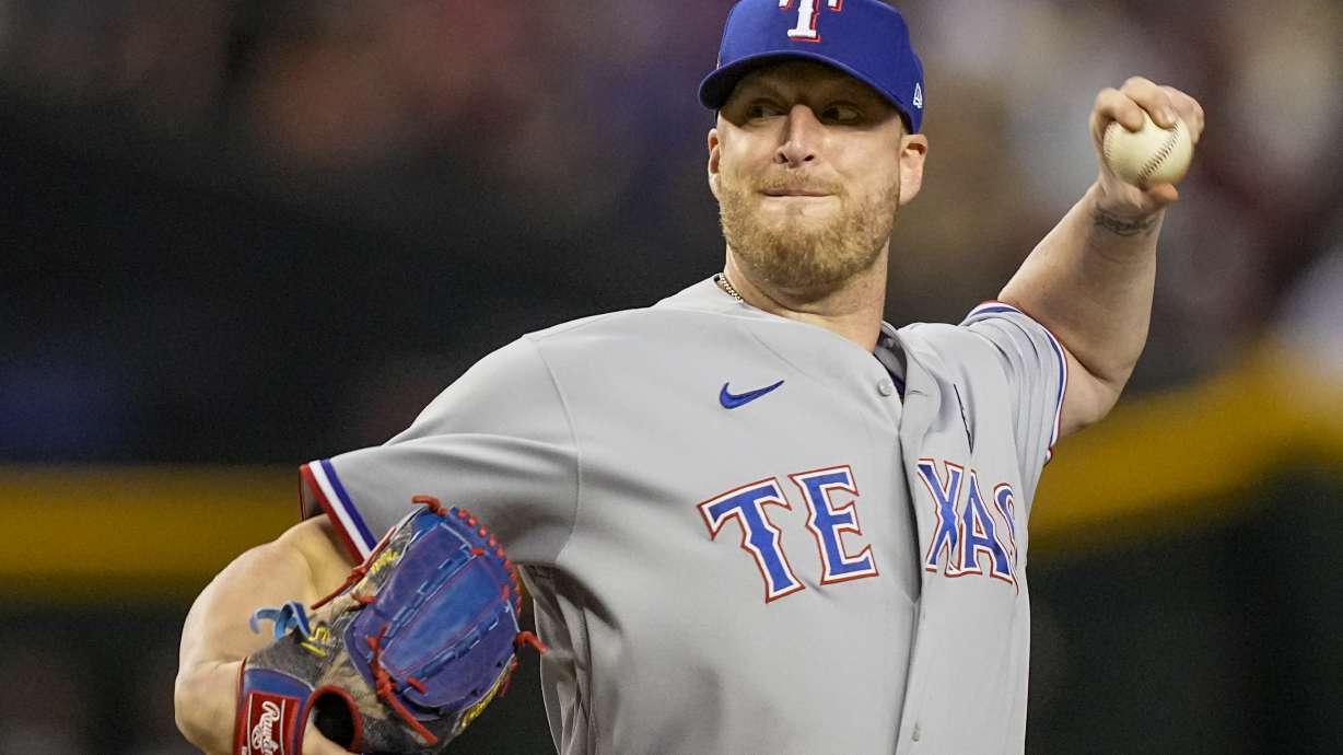 FILE - Texas Rangers relief pitcher Will Smith throws against the Arizona Diamondbacks during the ninth inning in Game 4 of the baseball World Series, Oct. 31, 2023, in Phoenix. Left-handed reliever Smith, who has won World Series rings the past three seasons with three different organizations, has agreed to a $5 million contract with the Royals, a person with knowledge of the deal told The Associated Press on Sunday, Dec. 10.