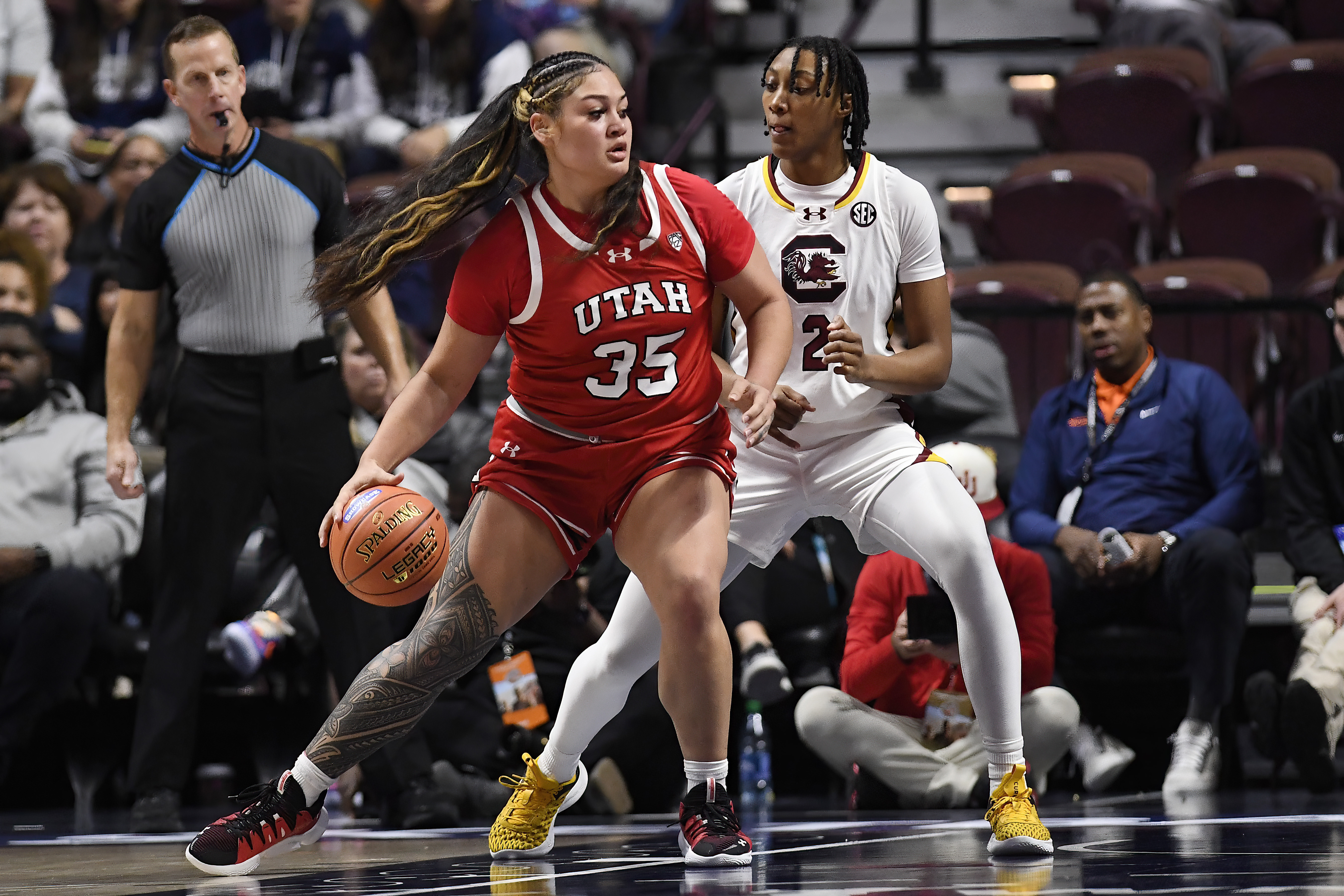 Utah forward Alissa Pili (35) is guarded by South Carolina forward Ashlyn Watkins (2) in the first half of an NCAA college basketball game, Sunday, Dec. 10, 2023, in Uncasville, Conn.