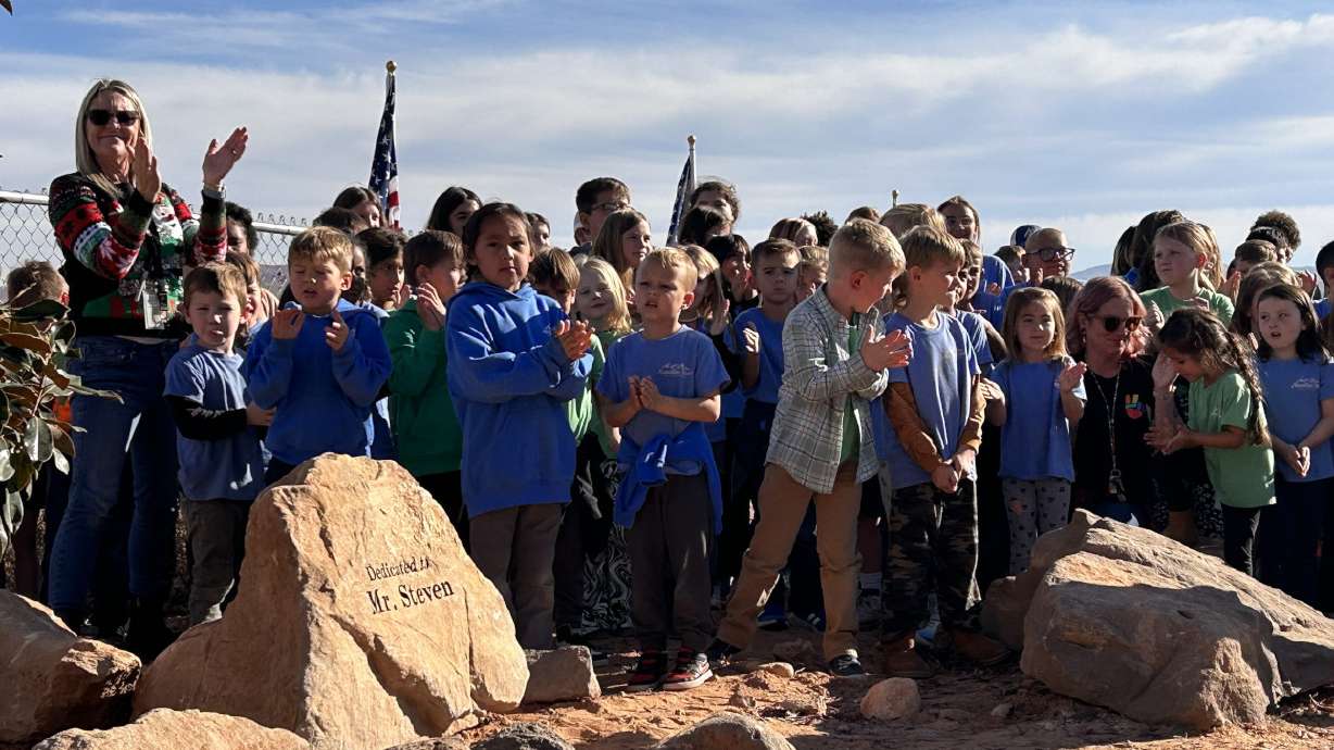 Mountain View Montessori School claps for their former custodian Steven Ricks during a ceremony to honor him, Washington City, Thursday.
