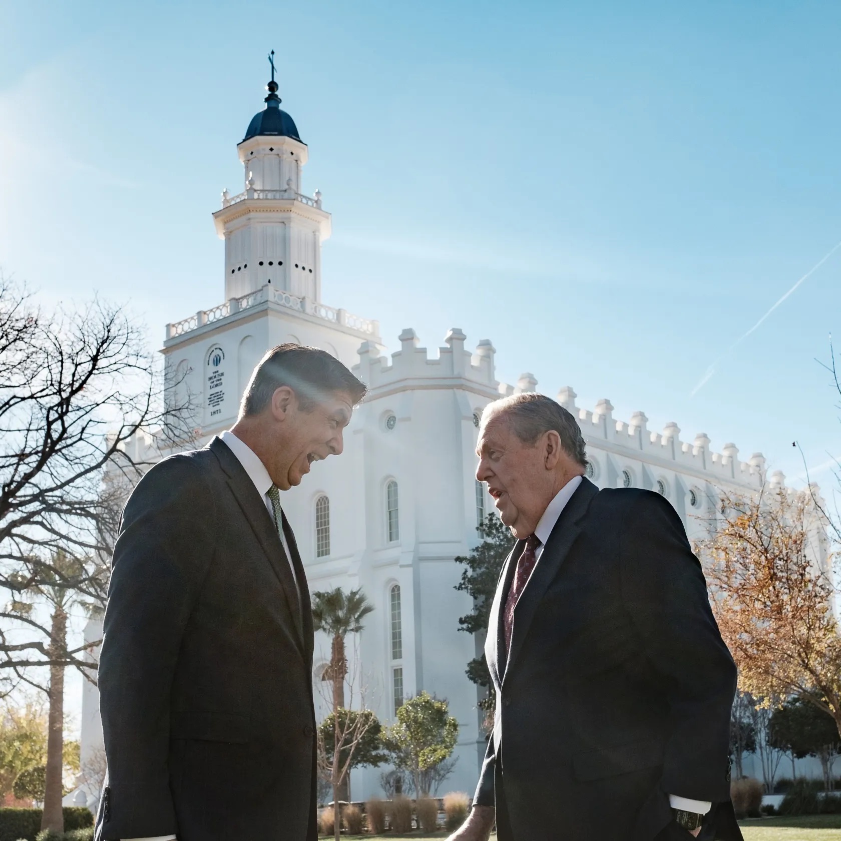 President Jeffrey R. Holland, acting president of the Quorum of the Twelve Apostles of The Church of Jesus Christ of Latter-day Saints, left, visits with his son, Elder Matthew S. Holland, a General Authority Seventy, outside the St. George Utah Temple on Saturday.