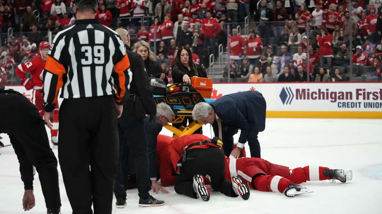 Detroit Red Wings center Dylan Larkin (71) is helped by medical staff after being hit against the Ottawa Senators in the first period of an NHL hockey game Saturday, Dec. 9, 2023, in Detroit.
