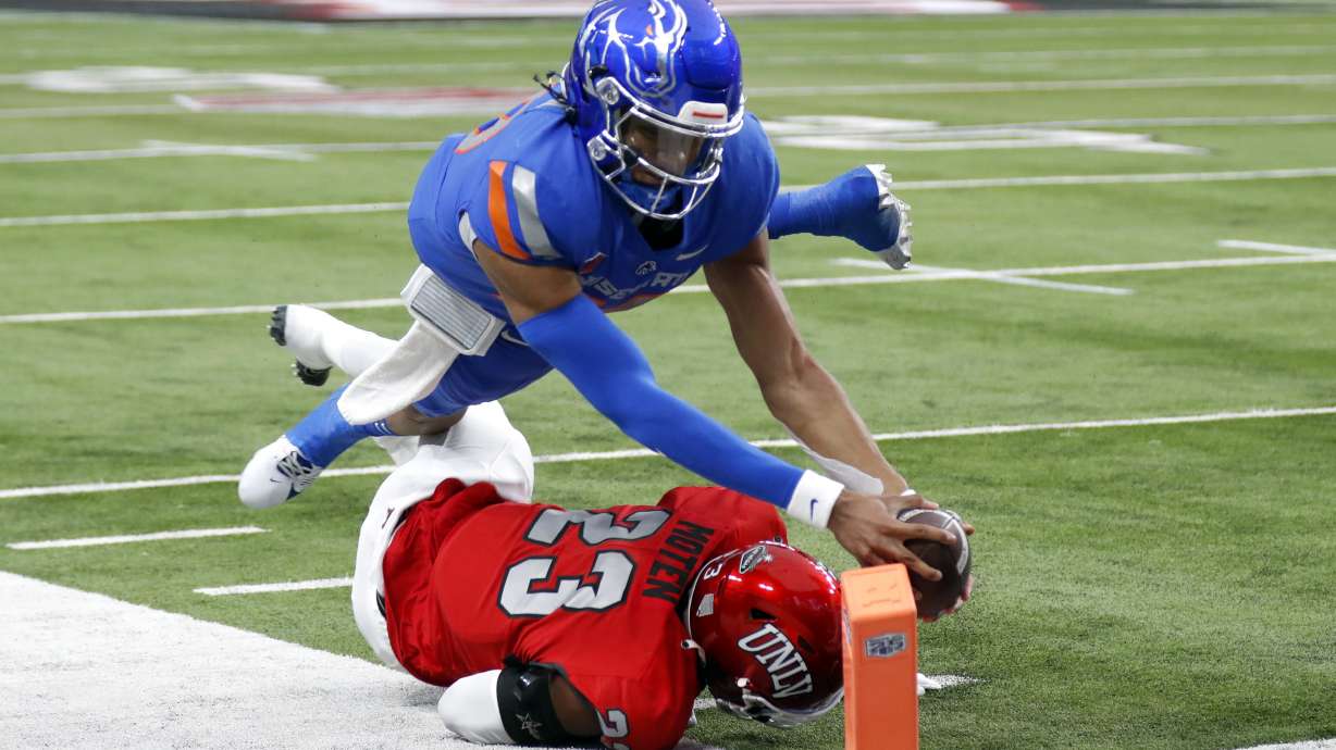 Boise State quarterback Taylen Green (10) dives over UNLV defensive back Quentin Moten (23) for a touchdown during the first half of the Mountain West championship NCAA college football game Saturday, Dec. 2, 2023, in Las Vegas.