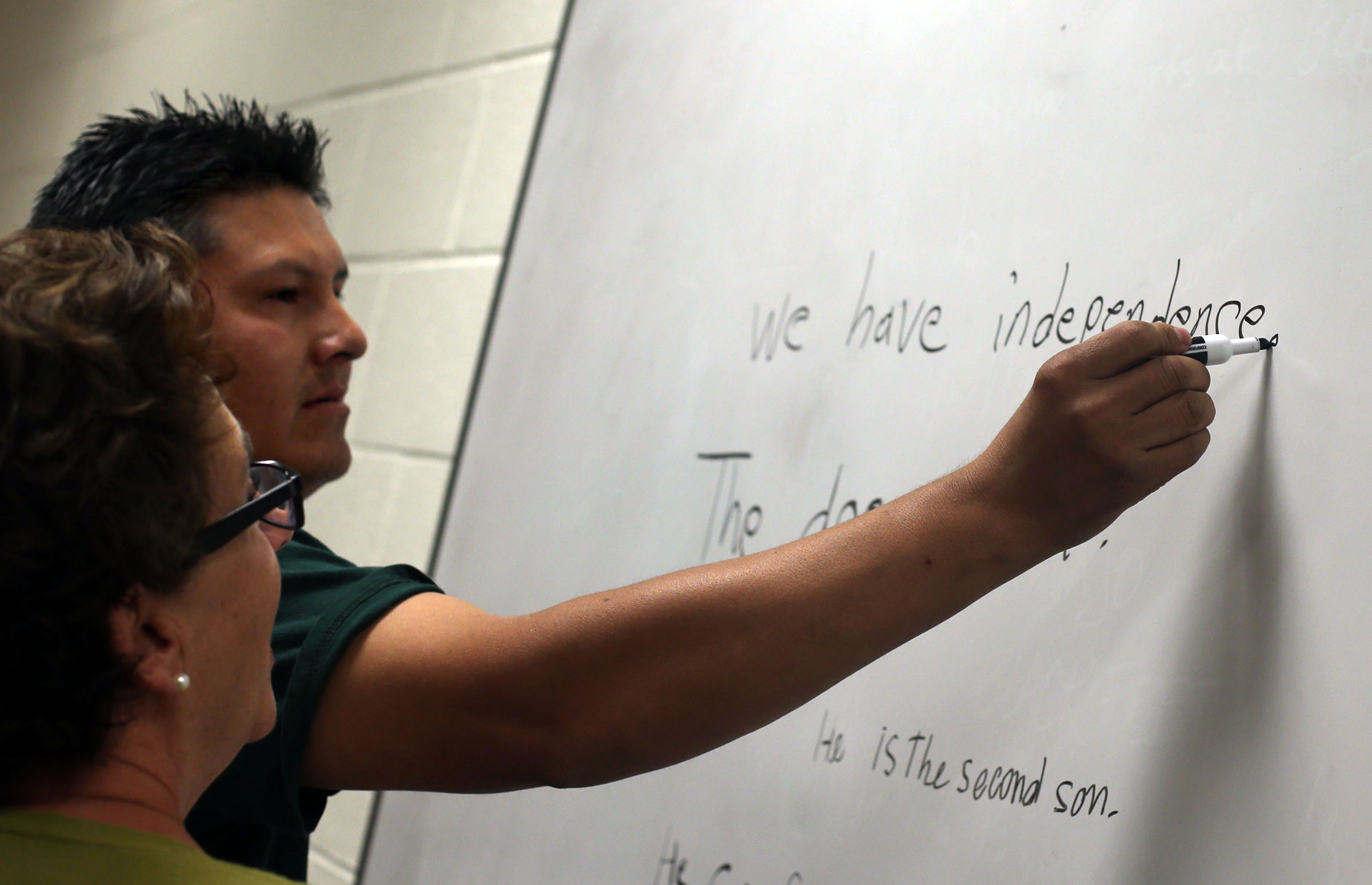 Ubaldo Miranda practices spelling with teacher Linda Tippets at the English Skills Learning Center in Glendale Middle School in Salt Lake City on Oct. 9, 2013. The share of people speaking only English at home in Utah has fallen slightly since 2010.