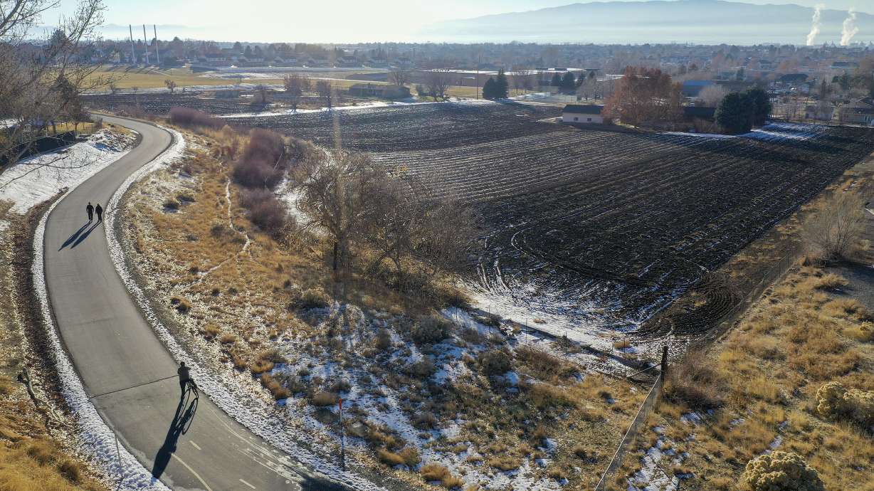 People walk and bike on the Murdock Canal Trail in Lindon on Dec. 21, 2020. A new legislative proposal would turn old canals into transportation access and recreation areas.