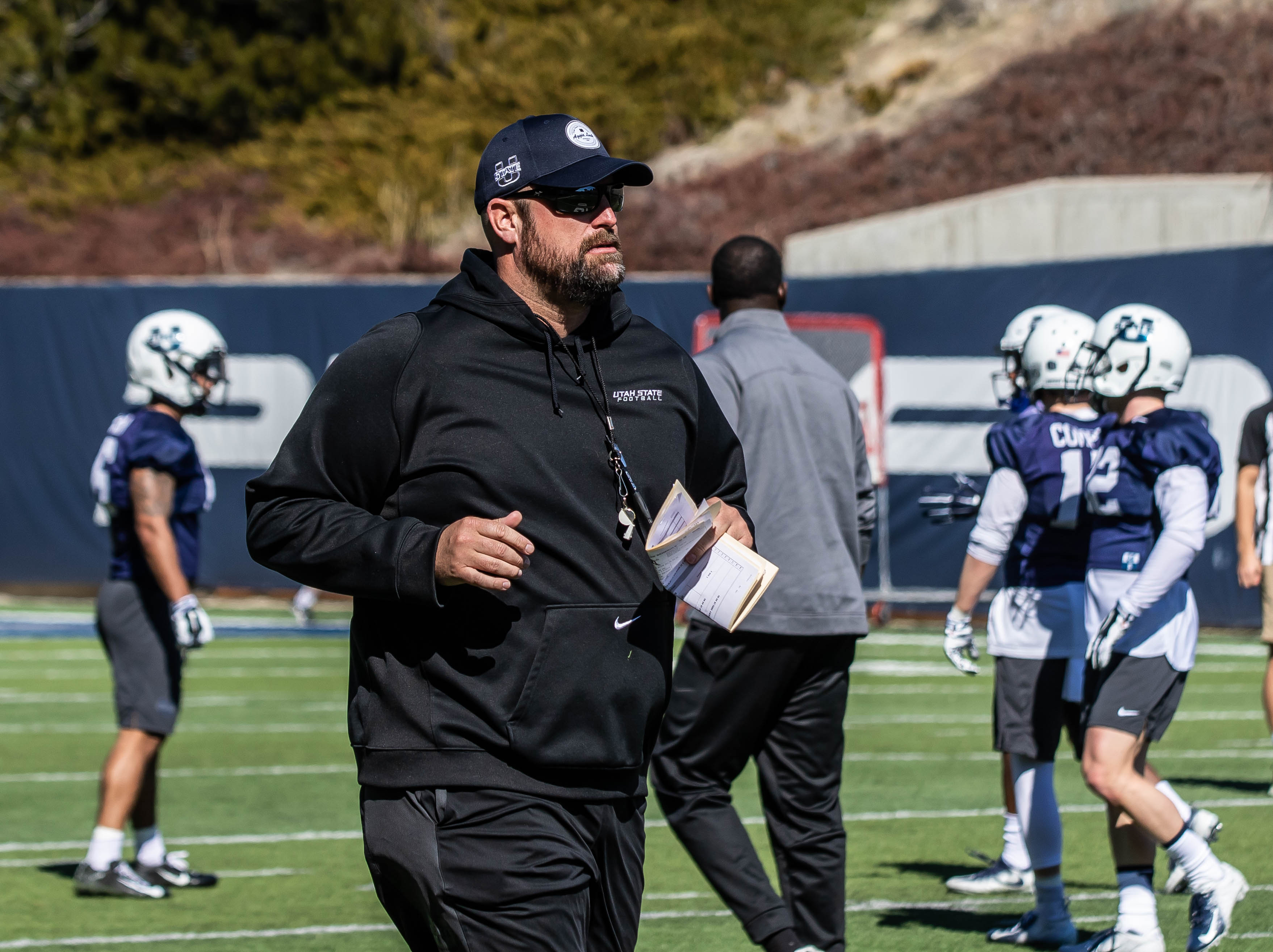 Former Utah State offensive line coach TJ Woods, seen here during practice with the Aggies in 2011, will reportedly join head coach Kalani Sitake's staff at BYU after Georgia Southern's bowl game, as first reported by ESPN's Pete Thamel.