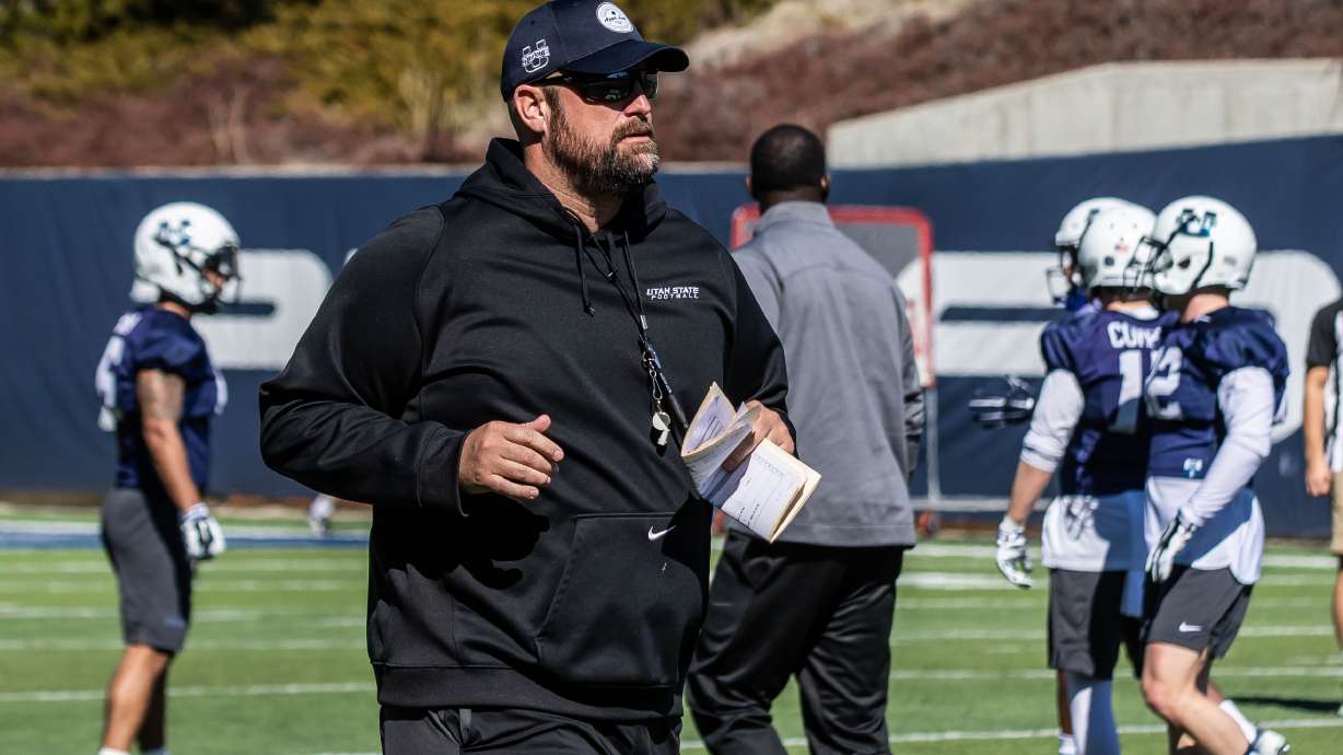 Former Utah State offensive line coach TJ Woods, seen here during practice with the Aggies in 2011, will reportedly join head coach Kalani Sitake's staff at BYU after Georgia Southern's bowl game, as first reported by ESPN's Pete Thamel.