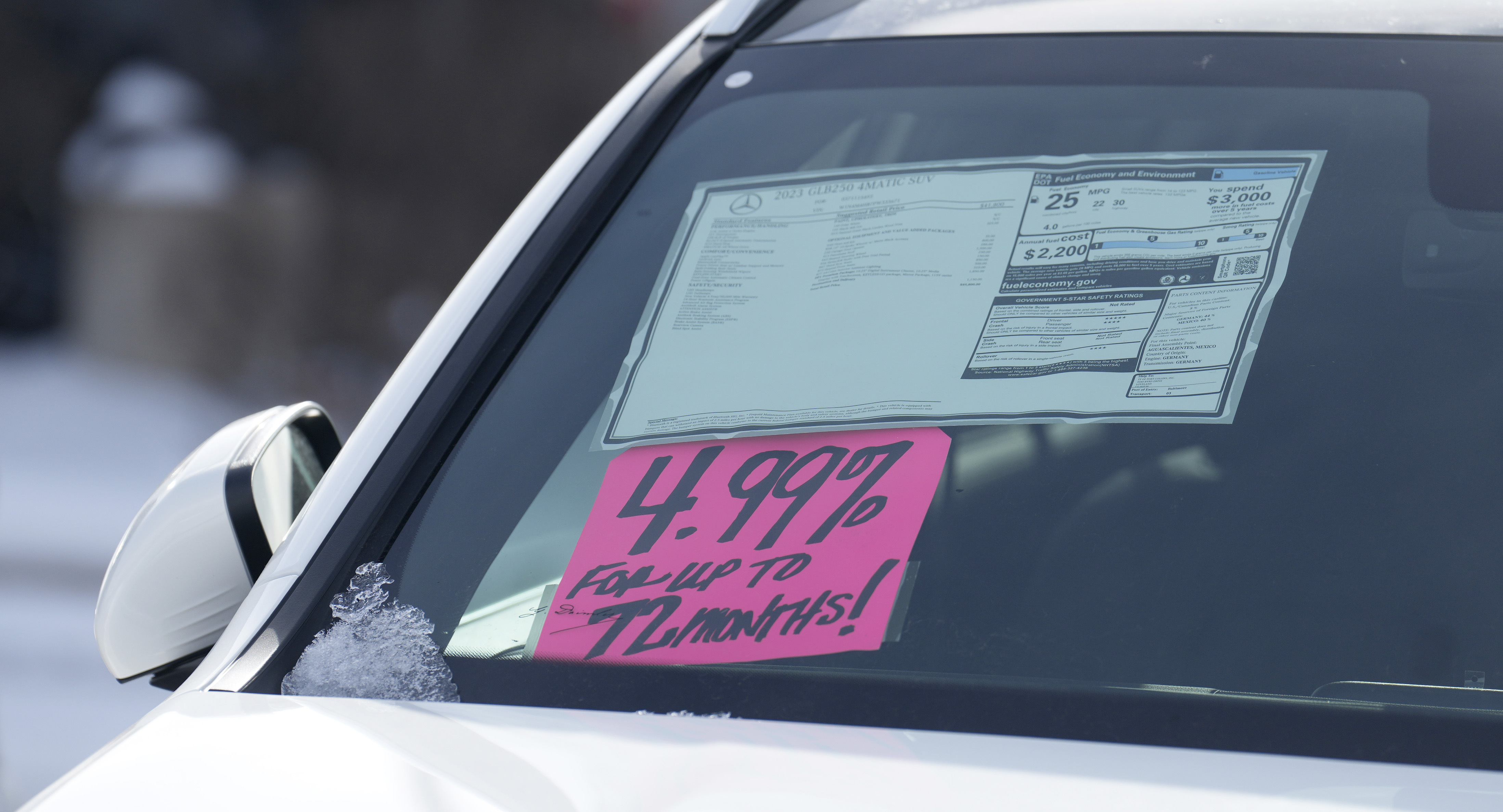 A sign highlighting the financing interest rate is displayed near the price sticker on an unsold 2023 vehicle at a Mercedes-Benz dealer on Nov. 30, in Loveland, Colo.