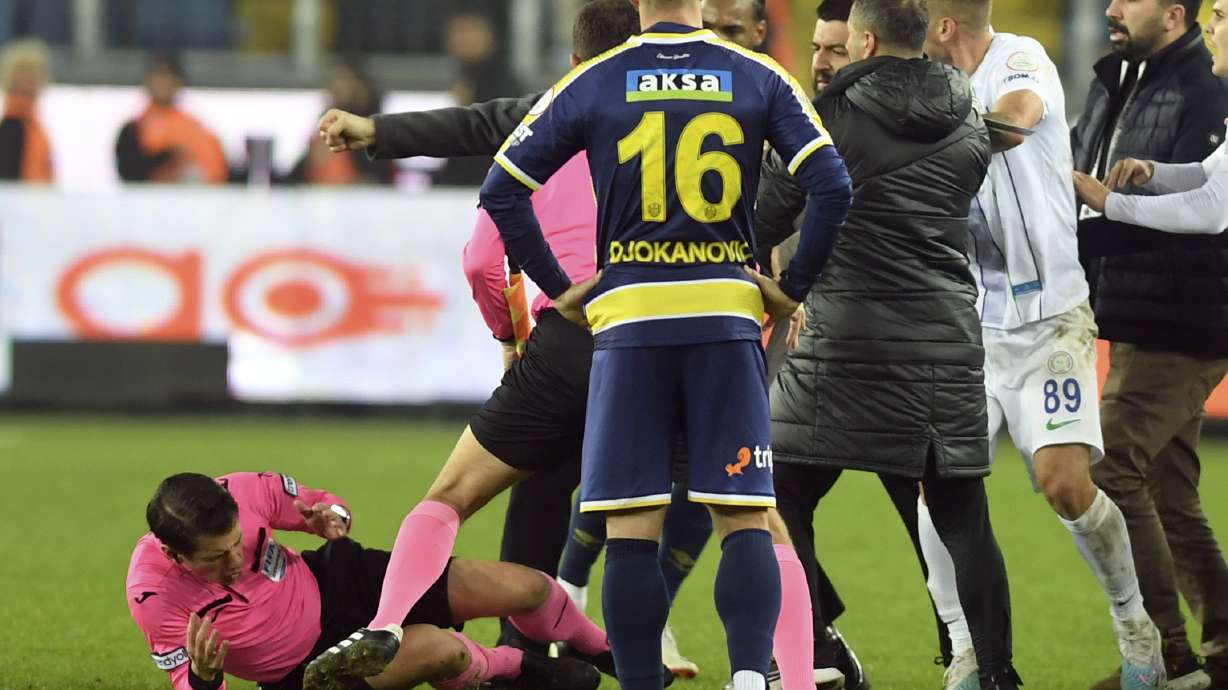 Referee Halil Umut Meler, left, falls down after being punched by MKE Ankaragucu president Faruk Koca, barely seen second left, at the end of the Turkish Super Lig soccer match between MKE Ankaragucu and Caykur Rizespor in Ankara, Monday, Dec. 11, 2023. The Turkish Football Federation has suspended all league games in the country after a club president punched the referee in the face at the end of a top-flight match. Koca was arrested Tuesday, Dec. 12, 2023 along with two other people on charges of injuring a public official following questioning by prosecutors.