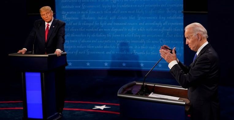 Joe Biden answers a question as Donald Trump listens during the second and final presidential debate in Nashville, Tenn., Oct. 22, 2020. A rematch next year between Biden and Trump would be closely fought, a new Reuters/Ipsos poll found.