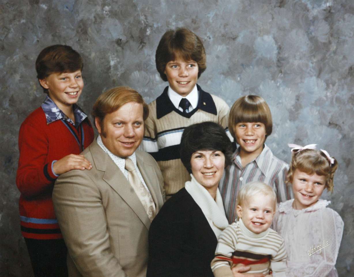 A portrait of Larry H. Miller, his wife Gail Miller, and their children taken in 1978. The children are, from top left, Roger, Greg, Steve, Brilliant and Karen.