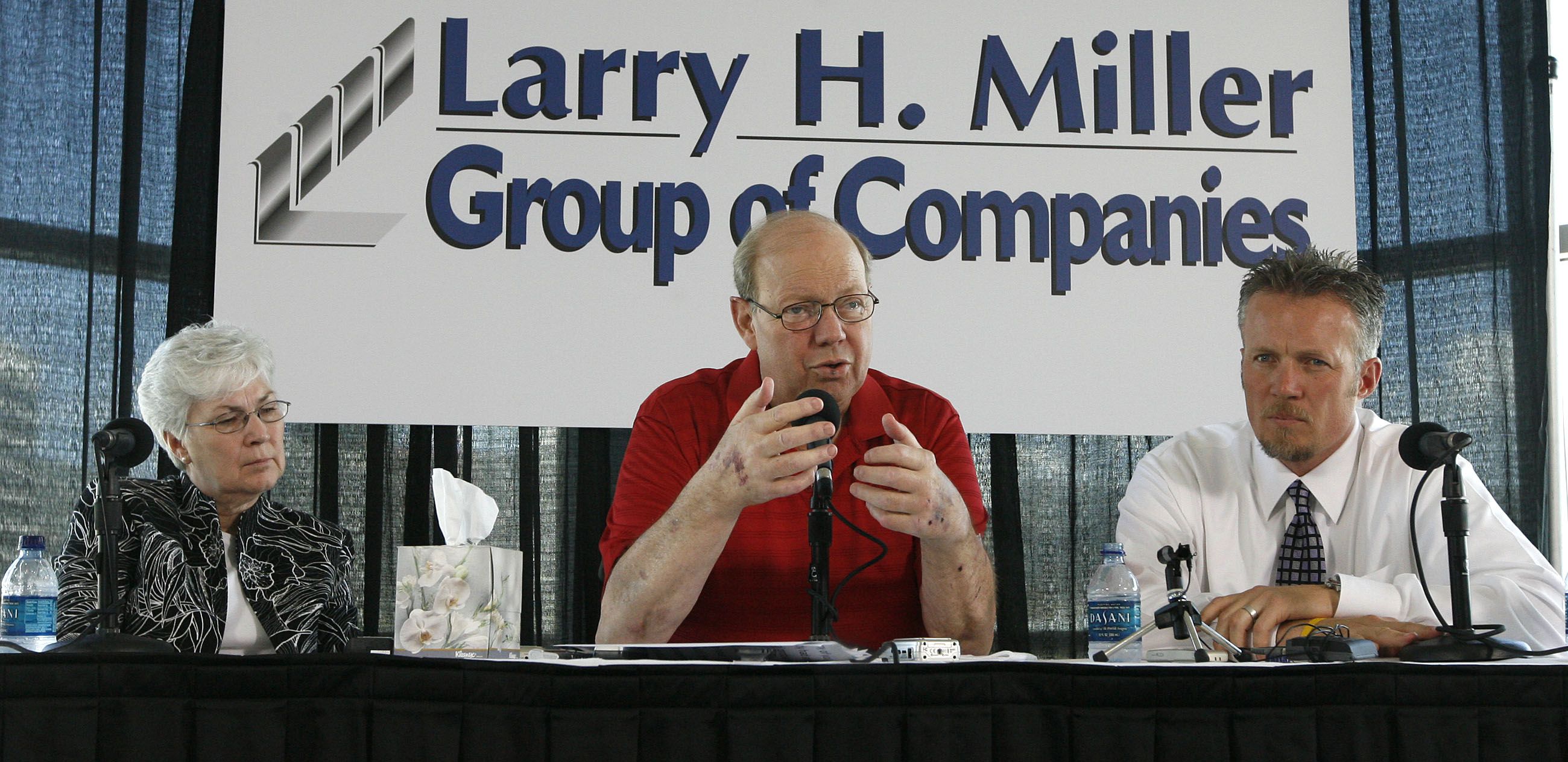Larry H. Miller talks at a press conference after being released from a long stay in the hospital fighting numerous health problems in Salt Lake City on Aug. 8, 2008. His wife, Gail Miller, and son, Greg Miller, are seated next to him.