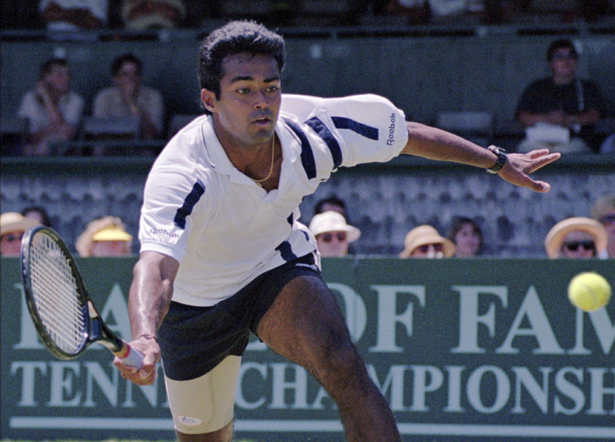 FILE - Leander Paes, of India, tries to maintain his balance while charging the ball during the quarterfinals of the Hall of Fame Tennis Championships in Newport, R.I., Thursday, July 10, 1997. Paes, who won 18 Grand Slam titles in men’s doubles or mixed doubles, and Vijay Amritraj are the first Asian men elected to the International Tennis Hall of Fame. The Hall announced its Class of 2024 on Wednesday., Dec. 13, 2023. 