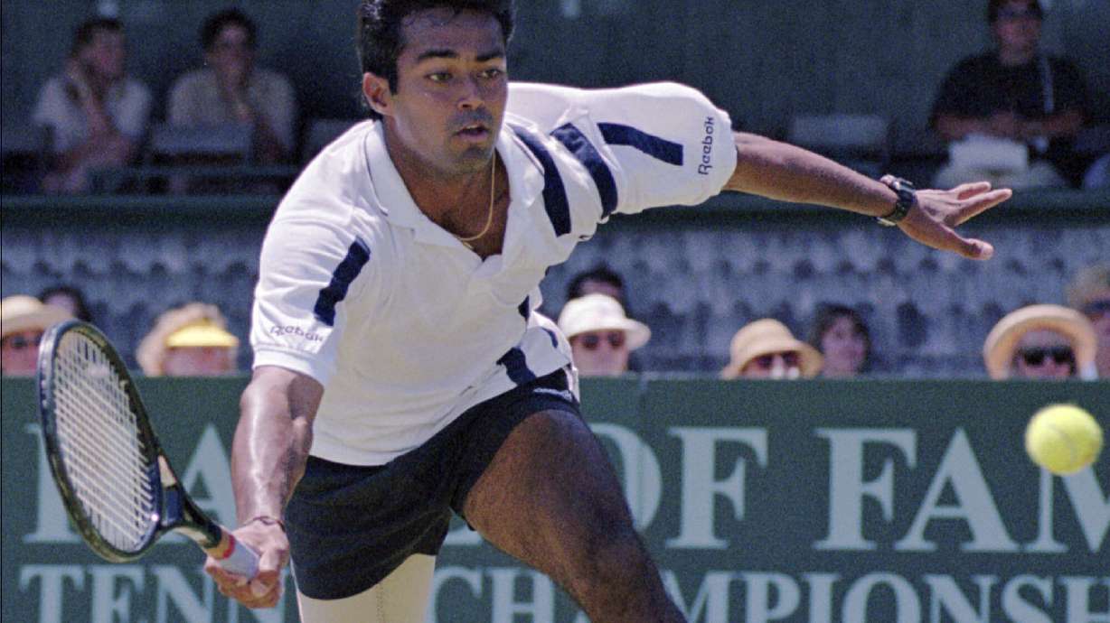 FILE - Leander Paes, of India, tries to maintain his balance while charging the ball during the quarterfinals of the Hall of Fame Tennis Championships in Newport, R.I., Thursday, July 10, 1997. Paes, who won 18 Grand Slam titles in men’s doubles or mixed doubles, and Vijay Amritraj are the first Asian men elected to the International Tennis Hall of Fame. The Hall announced its Class of 2024 on Wednesday., Dec. 13, 2023.