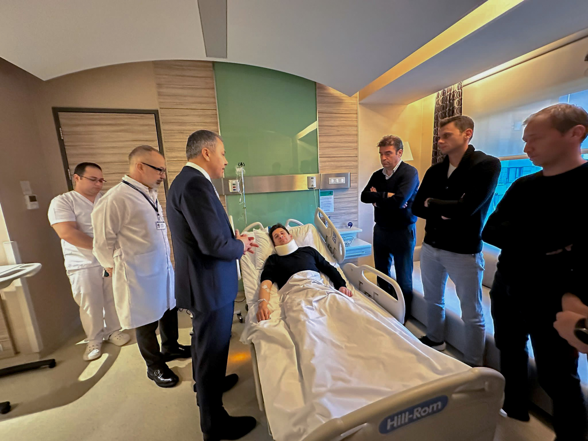 In this handout photo released by Turkish Interior Ministry, Turkish referee Halil Umut Meler, center, rests in a bed as he talks to Turkish Interior Minister Ali Yerlikaya, third left, at Acibadem hospital in Ankara, Tuesday, Dec. 12, 2023. The Turkish Football Federation has suspended all league games in the country after a club president punched the referee in the face at the end of a top-flight match.